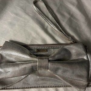 Silver Kate Spade wristlet clutch with bow